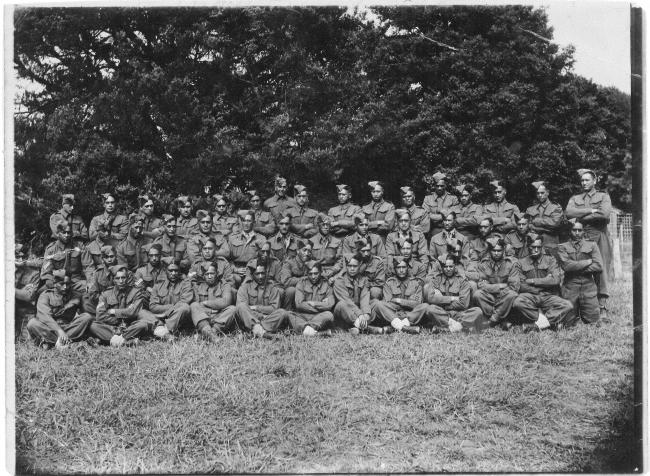 A photograph of 50 uniformed soldiers in the Second World War in four rows.