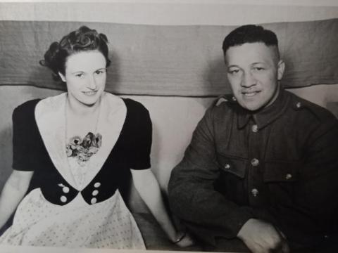 A woman in civilian clothing with a man in uniform.