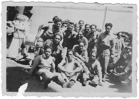 A group of soldiers on the deck of a ship. 