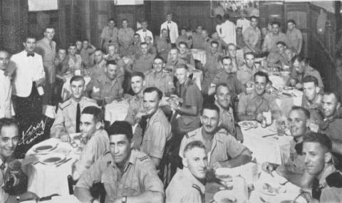Group of soldiers seated at tables